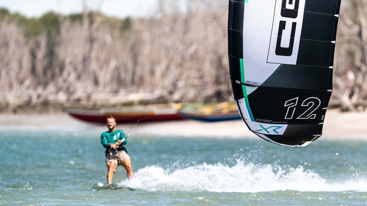 Kitesurfing action with a rider and a CORE kite, illustrating the excitement of the sport and its gear.