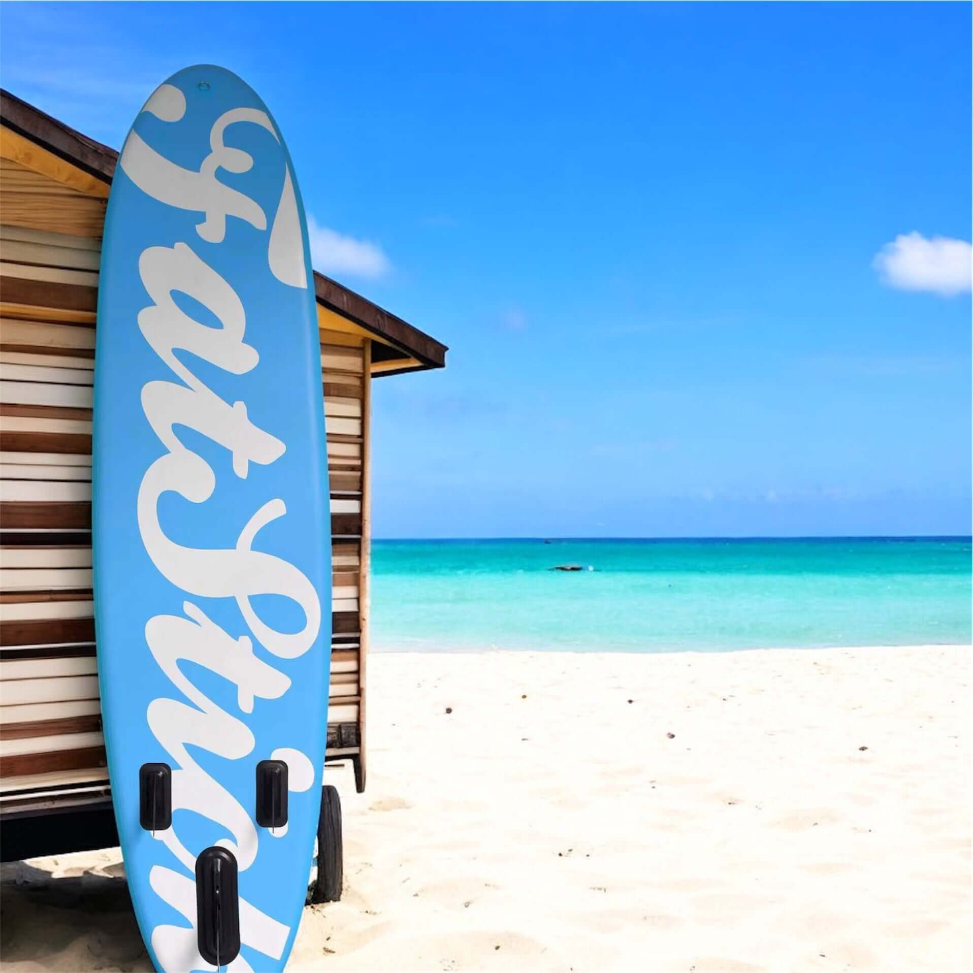 Fatstick AirStick 10'6 Inflatable SUP Package 2026 on a sandy beach with ocean in background.