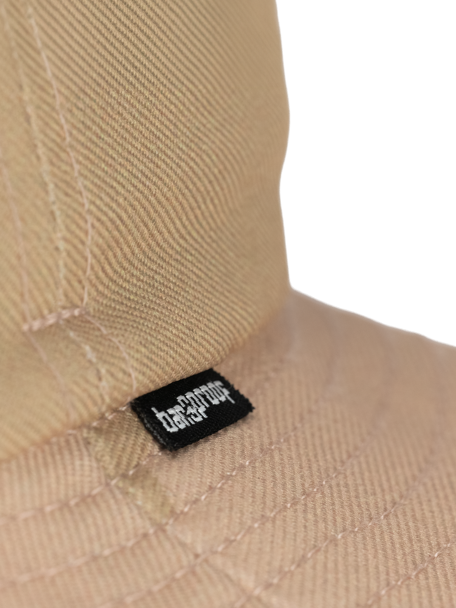 Close-up image of the unique texture and brand tag on a stylish beige bucket hat.