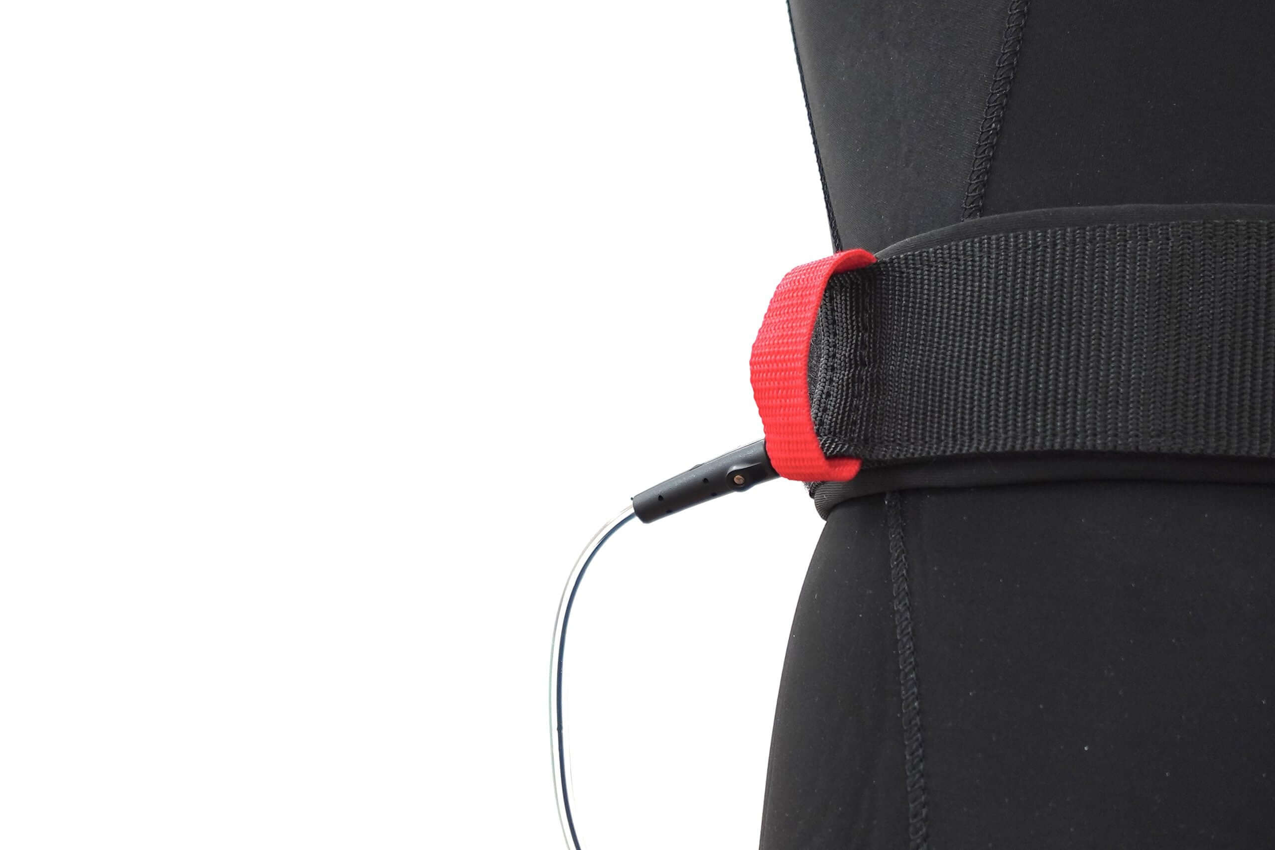 Wingfoil board waist leash attached to a wetsuit, showcasing safety and control features for water sports.