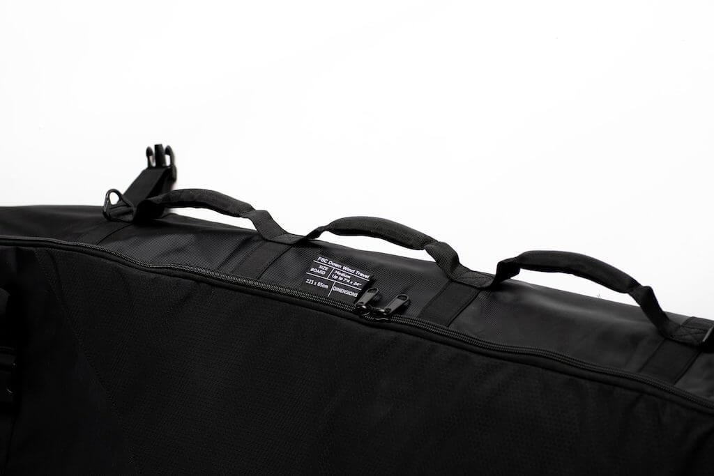 Black carrying case with handles and straps on a white background