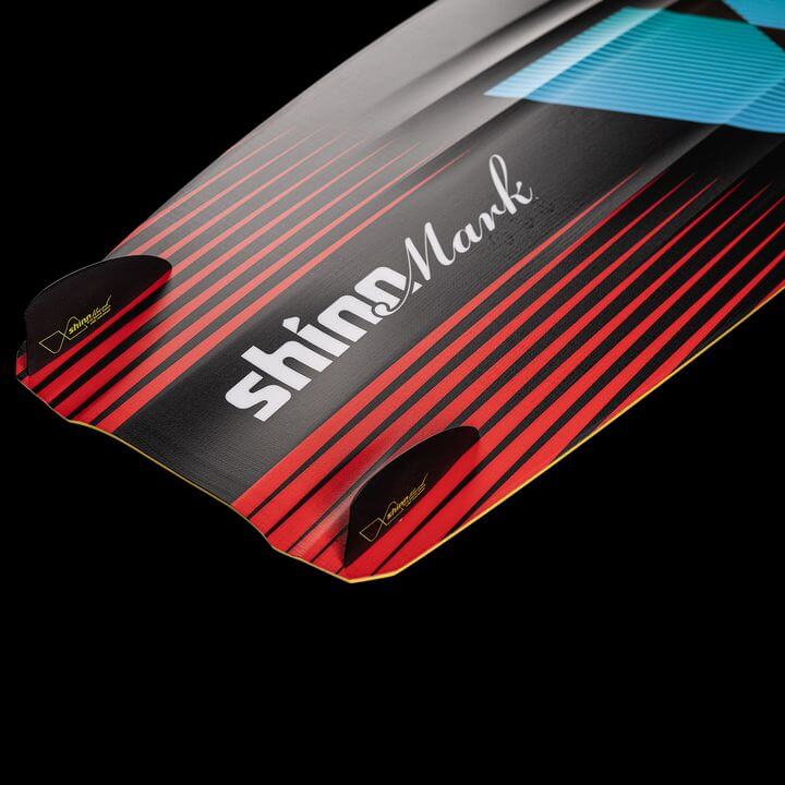Shinn Monker Kiteboard 2025 – Smooth Control & Comfort showcasing vibrant red and black design with fins.