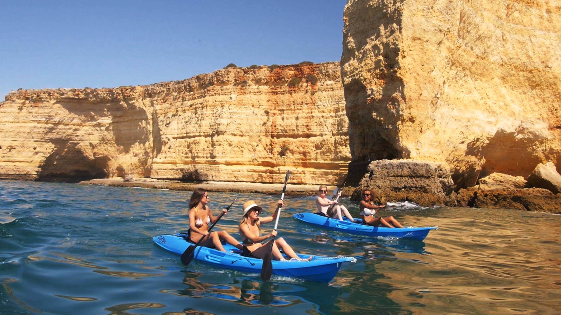 Group of adventurers enjoying the 'MAHEE' Double Seater Kayak Blue Package Deal 🔵 on a sunny waterway.