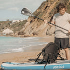 Fatstick AirStick 10'6 Inflatable SUP Package 2026 with paddler on the beach during a sunny day.