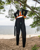 C-Monsta Wetsuit Hanger V2 Orange | High-Visibility Gear Dryer holding wetsuit and boots on a beach tree.