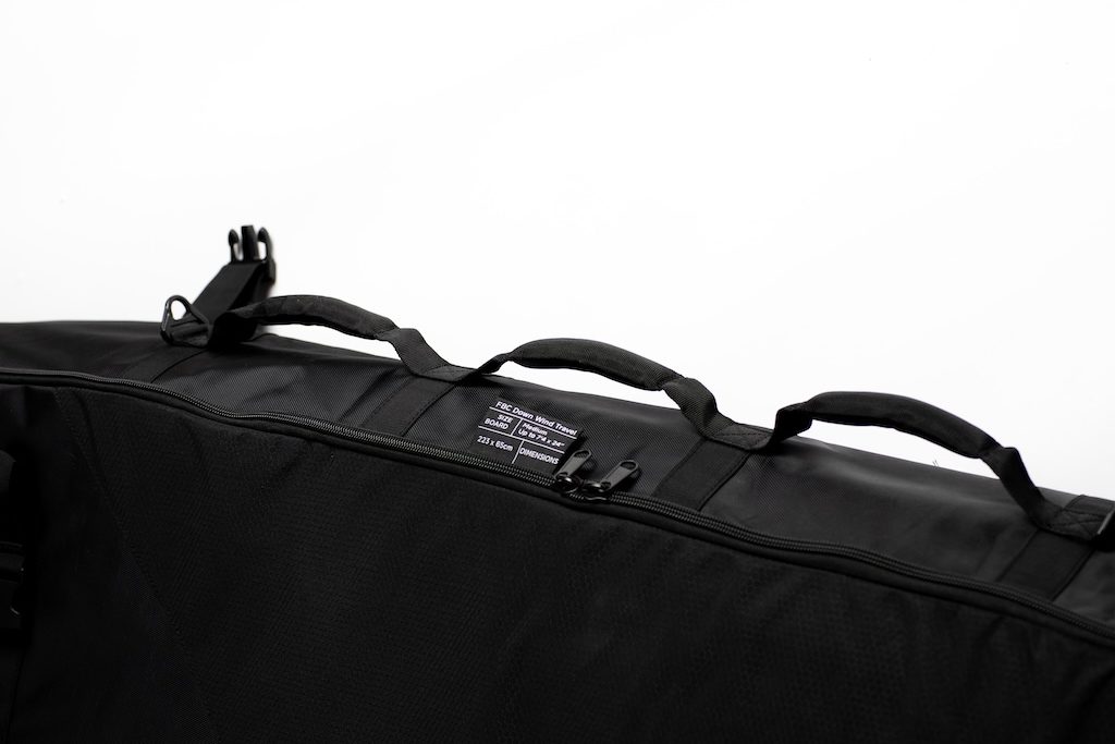 Black carrying case with handles and straps on a white background