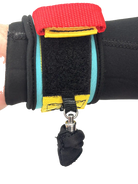 FBC Wingfoil Wrist Leash showing a colorful design with a secure fit on a wrist in a wetsuit.