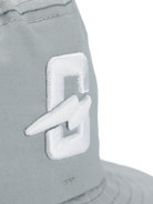 Close-up of the embroidered logo on a gray hat featuring a stylish design.