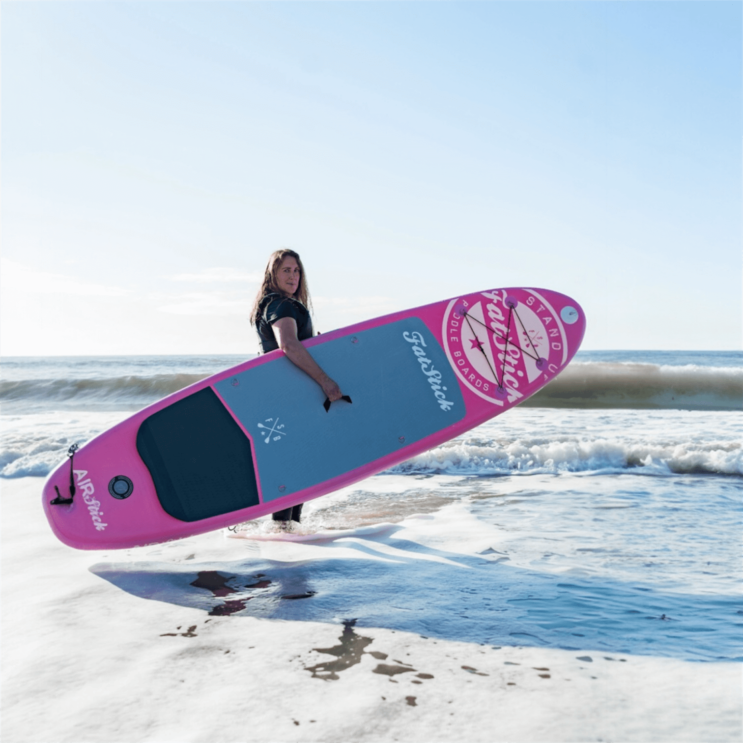 Fatstick AirStick 10'6 Inflatable SUP Package 2026 on the beach with a user paddling.