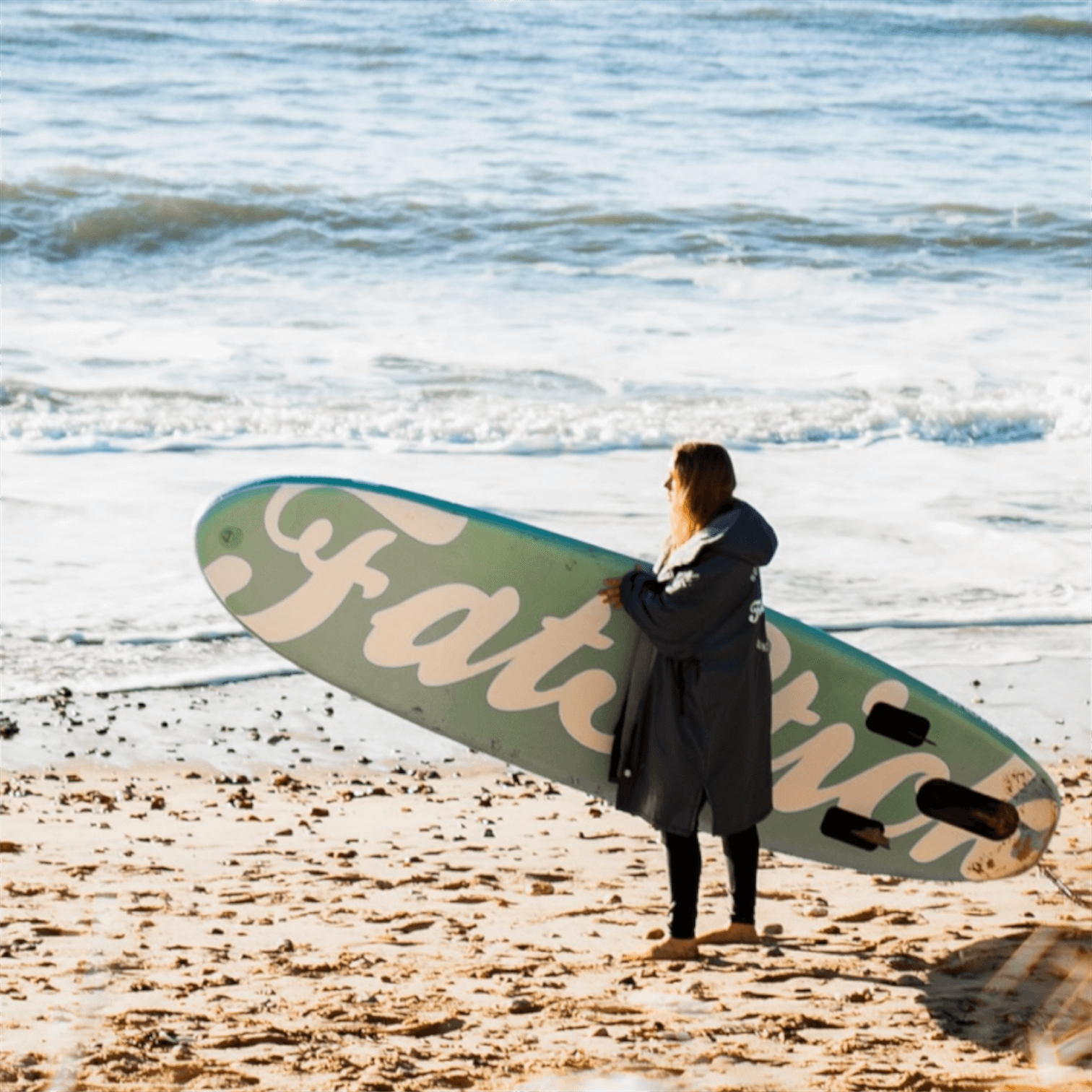 Fatstick AirStick 10'6 Inflatable SUP Package 2026 on the beach with a paddler ready to enjoy the water.