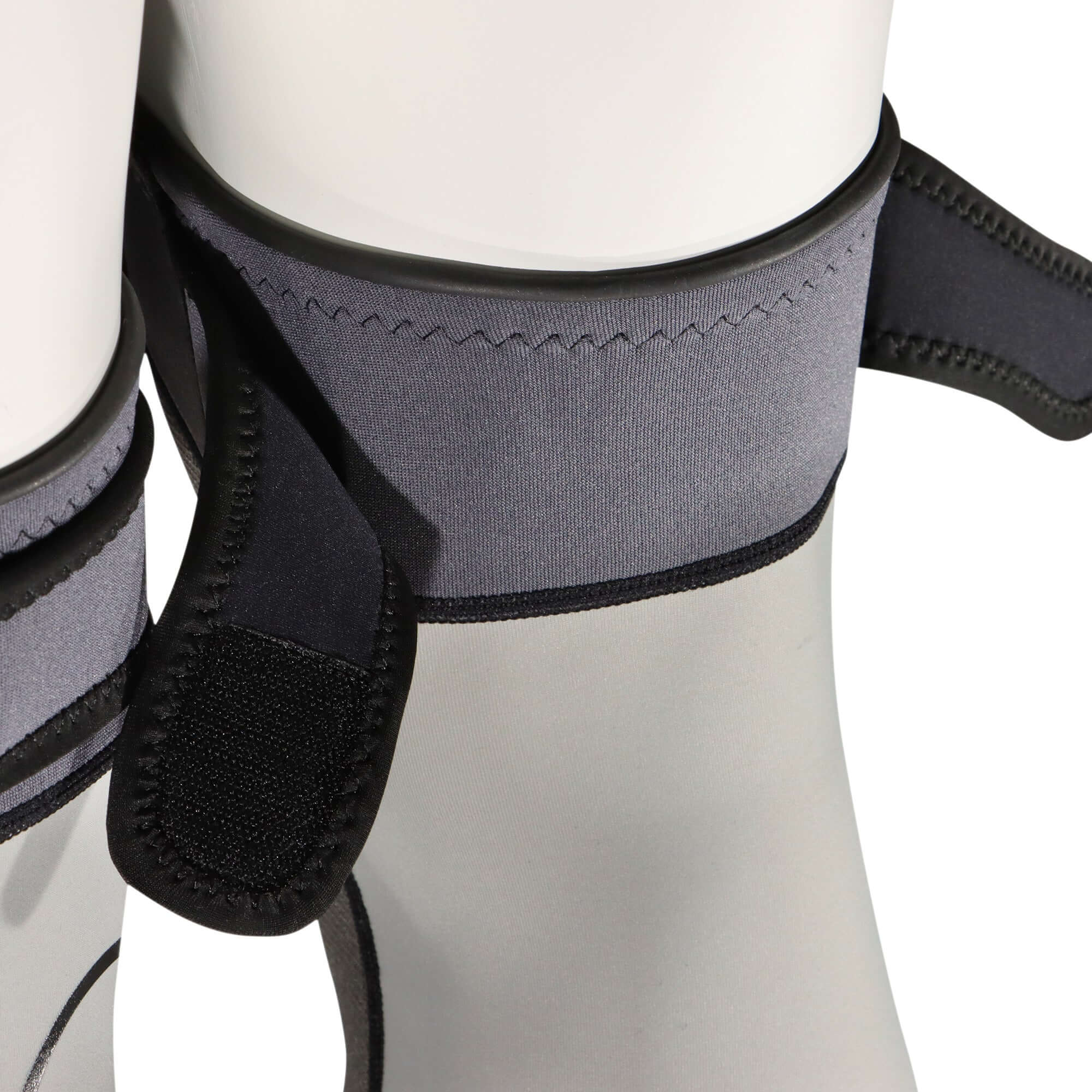 Close-up of knee and shin protection sleeves for wingfoil by FORWARD WIP, showcasing adjustable straps and flexible material.