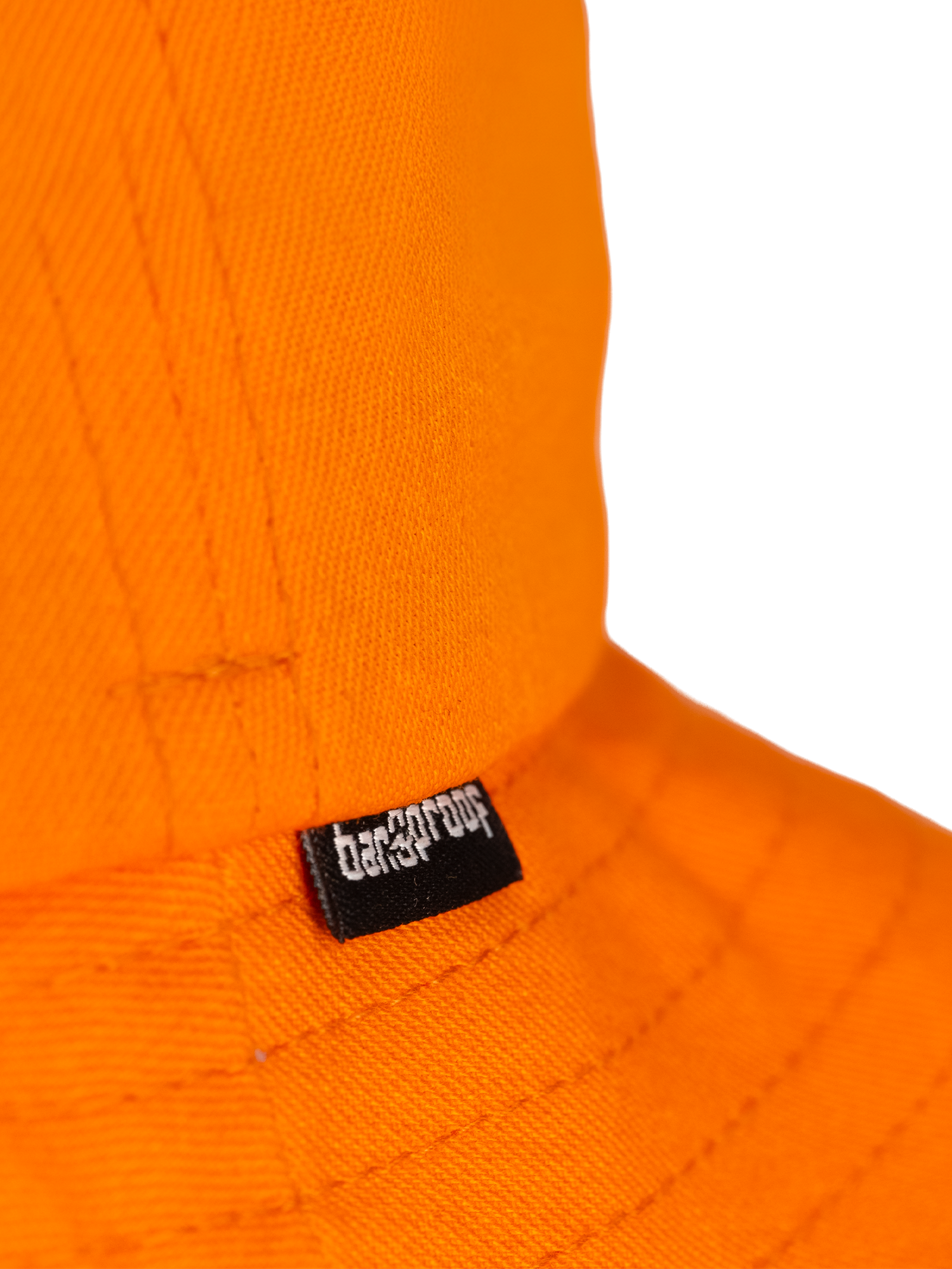 Close-up of an orange hat featuring Bangproof brand tag, showcasing vibrant color and quality craftsmanship.