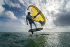 Ozone Flux V2 Ultra-X – Freeride Without Limits performer foiling over ocean waves.