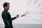 Ozone Pocket Rocket V1 – Parawing Foiling Freedom in action by a man in a wetsuit.