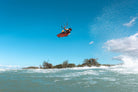 Ozone Code V5 Kiteboard – Freeride Performance Twintip in action, rider jumping over water