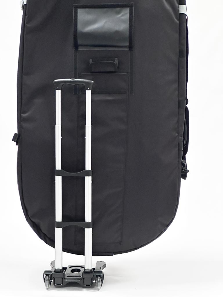 A black wing foil travel bag with wheels and a telescoping handle, designed for transporting board sports equipment.