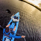 Two people paddling the 'MAHEE' Double Seater Kayak Blue Package Deal 🔵 on tranquil waters.